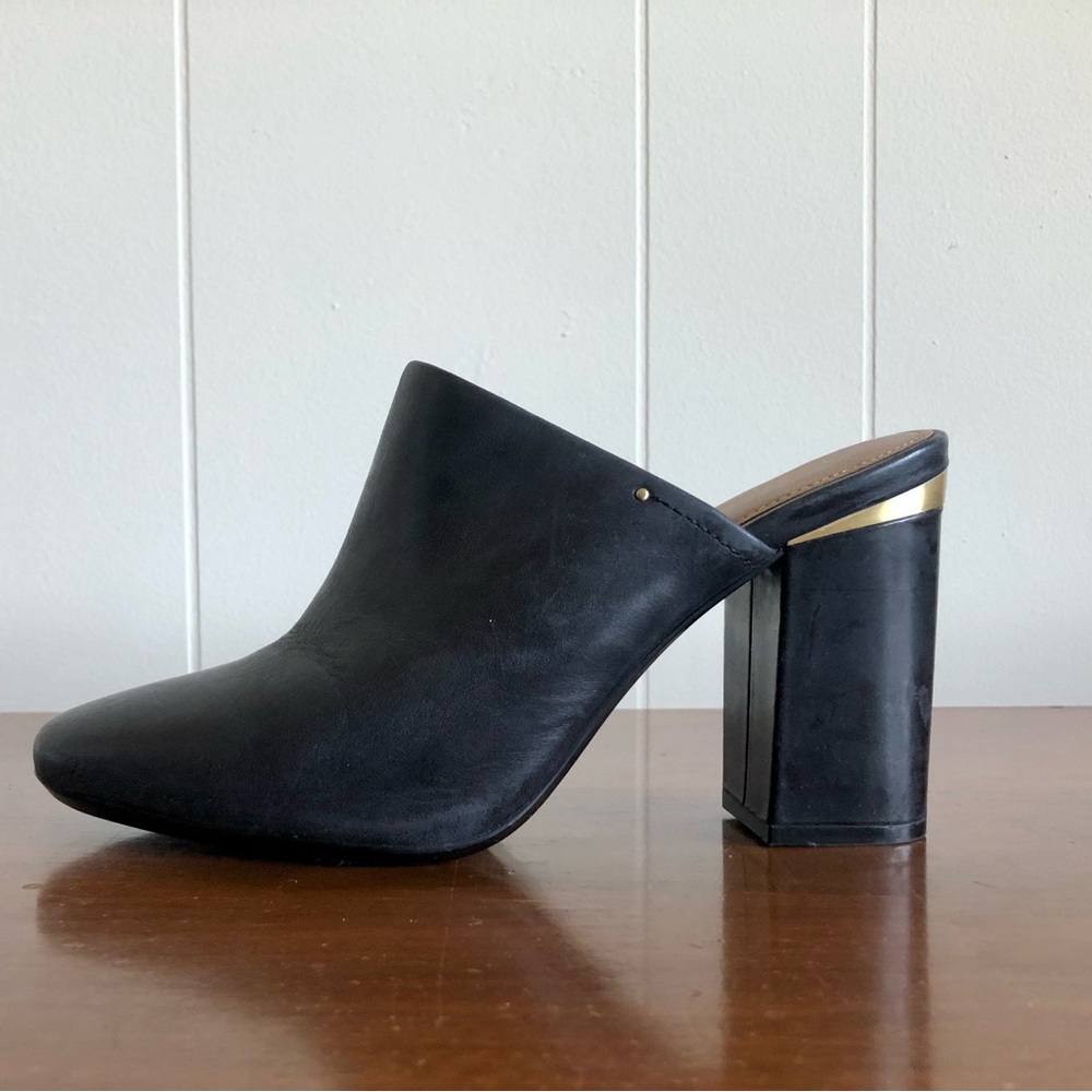 Dark blue Calvin Klein closed-toe shoes with gold accents